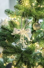Christmas tree decorating with shimmering silver ornaments and lights