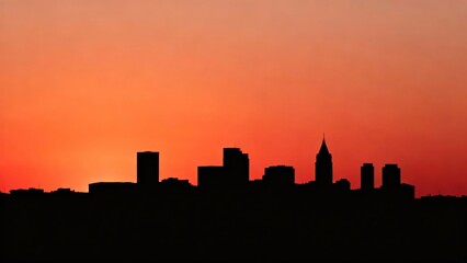 Silhouette of a city skyline at sunset with vibrant orange and red hues in the sky