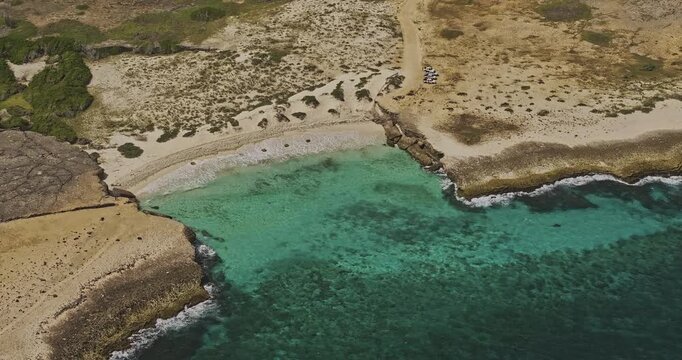 Bonaire Caribbean Netherlands Aerial v77 zoomed birds eye view fly around Playa Chikitu, capturing white sandy beach between two expansive rocky plateaus - Shot with Mavic 3 Pro Cine - Feb 3rd 2024