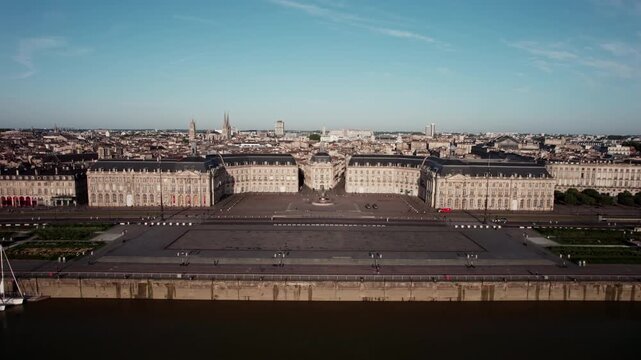 France, Bordeaux. Place de la Bourse. A large city with a large building in the center. The building is surrounded by a large plaz. Panoramic aerial view with a forward-moving panoramic drone shot.