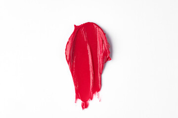 Red lipstick swatch smudged texture isolated on white with copy space for background. Beauty concept