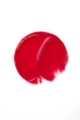 Red lipstick swatch smudged texture isolated on white with copy space for background. Beauty concept