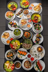 A large table with Asian cuisine