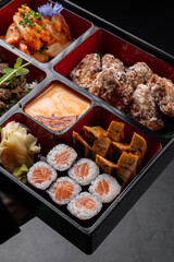 Japanese style bento box with sushi, kimchi, tofu