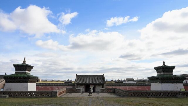 Wide panoramic view of Erdene Zuu Monastery, Mongolia. The ancient complex features massive white stupas and historic temple walls set against a vast landscape.
