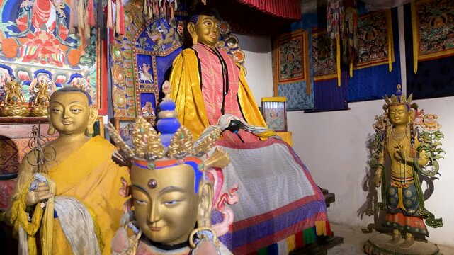Interior of Erdene Zuu Monastery, Mongolia. Features ancient gilded Buddhist statues, vibrant religious art, and ornate altar details within the country's oldest temple complex.