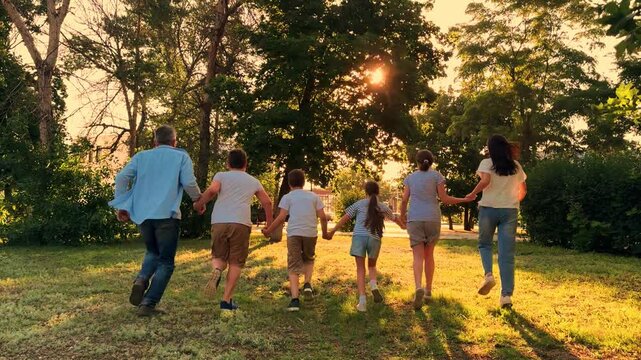 children parents run across field holding hands girl boy group people sunlight playing, Parents and Children Enjoying Life, Cheerful Family Makes Memories, Holding Hands, Chasing Dreams, Generations