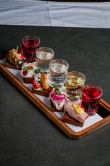 A vibrant assortment of small bites paired with colorful drinks invites tasting and adventure