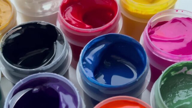 Set gouache paints in jars bright Color Close Up. Set of multicolor gouache on plastic jars.Creative drawing Art hobby.