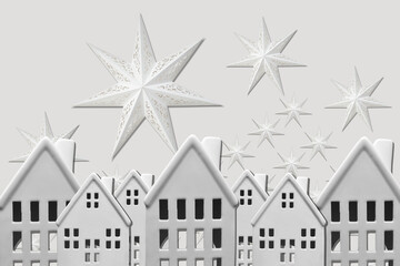 Collage with a ceramic houses and paper stars on background	
