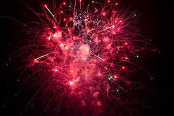 Holiday fireworks explode in the night sky. Selective focus.	