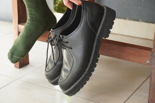 Close up of man using shoes - Powered by Adobe
