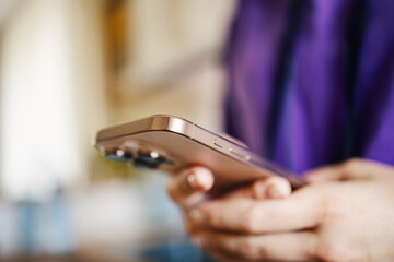 Person holding modern smartphone navigating digital content