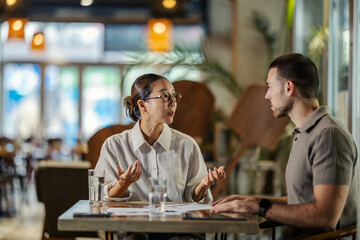 Colleagues having business meeting in a cafe