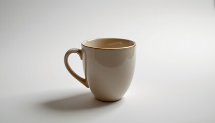 Fototapeta premium A simple yet elegant setting featuring a light beige coffee mug resting on a white surface
