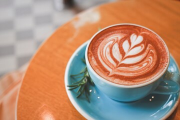 Artistic latte coffee with heart and leaf design