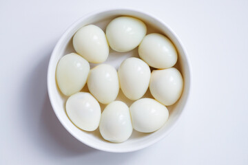 Boiled quail eggs on a white plate isolated on white background