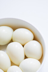 Boiled quail eggs on a white plate isolated on white background