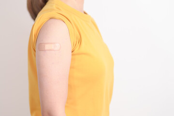Adult Woman with bandage after received vaccine. Vaccination and Immunization for Influenza, HPV,...