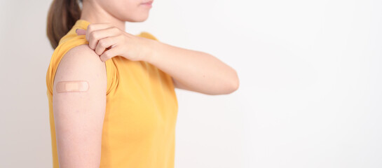 Adult Woman with bandage after received vaccine. Vaccination and Immunization for Influenza, HPV,...