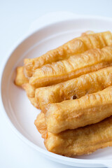 Cakwe or cakue is Indonesian-Chinese fried dough snack, isolated on white background