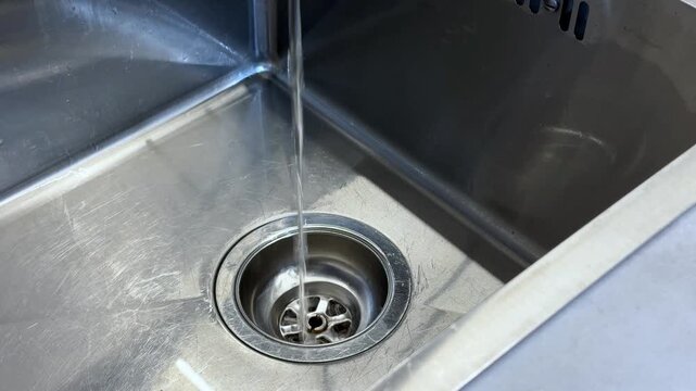 The Journey of Water Flowing Down a Stainless Steel Sink: Captivating Frames of Everyday Life