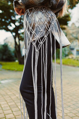 Creative fashion design showcasing unique macrame details in a vibrant outdoor setting during the afternoon