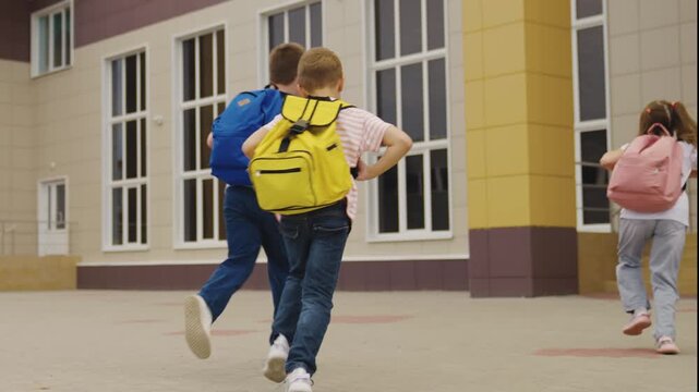 First day of school for children, Students with colorful backpacks, Children entering the school courtyard, Happy kids ready for lessons, Hopeful faces on a new morning, Education and friendship