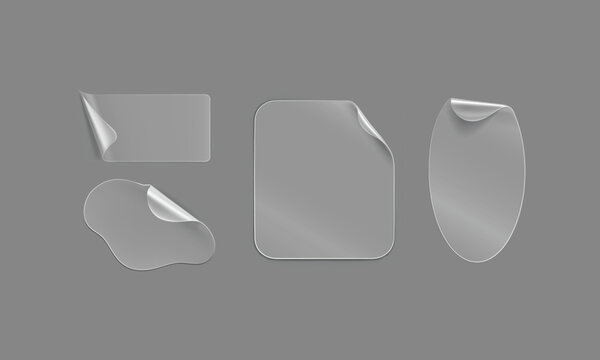 Set of various transparent blank adhesive stickers peeling off with curled corners on gray background