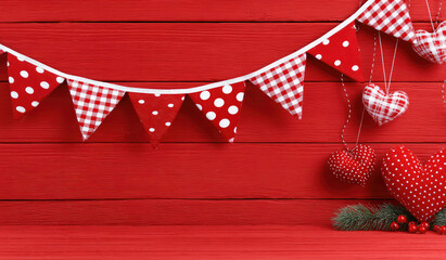 Red heart ornaments and pennant flags on wooden background