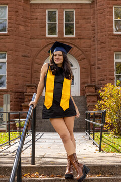 Female graduate outside stone architectural background