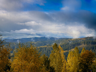 Sunny Autumn Carpathians with Puffy White Clouds