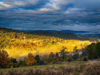 Sunny Autumn Carpathians with Puffy White Clouds