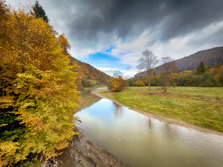 Sunny Autumn Carpathians with Puffy White Clouds