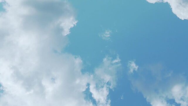 Air plane window view, aerial drone view sunny blue sky plump white clouds in sunlight on afternoon time lapse. Beautiful azure scyscraper and white cloudscape, atmosphere, blue sky cloud drone shot.