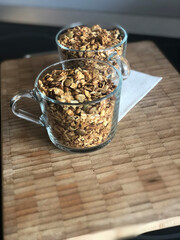 Healthy breakfast with muesli in glass cups on a wooden table