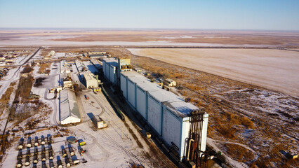 Fototapeta premium Aerial View of Large Industrial Grain Elevator and Silo Complex in Rural Landscape
