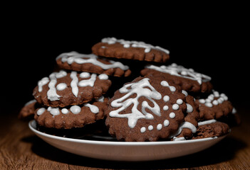 A stack of Christmas Eve gingerbread cookies, decorated with icing