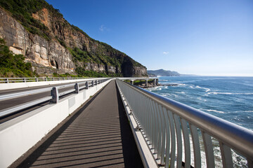 View of the famous Sea Cliff Bridge located on the Illawarra coastline north of Wollongong, NSW Australia. Captured from the scenic walkway looking north to Stanwell Park on a bright blue sunny day.