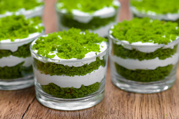 Green mint dessert in glass cups close-up, green and white layers