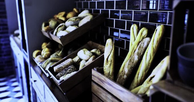 A warm, inviting corner of a bakery showcases various types of bread nestled in wooden baskets, highlighting the textures and colors of each loaf against a stylish backdrop.
