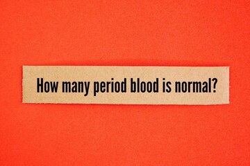 A square piece of paper with the words "How much period blood is normal?" about menstruation or menopause.