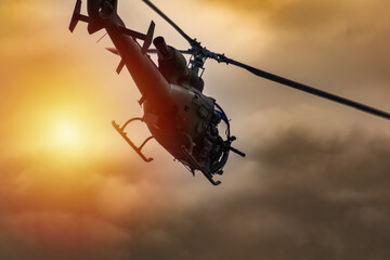 Obraz premium Silhouette of a combat helicopter in the sky, gazelle seen from underneath, air transportation