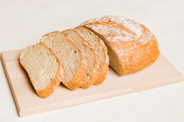 Assortment of freshly sliced baked bread with napkin on rustic table top view. Healthy unleavened bread. French bread slice