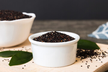 quinoa seeds in bowl on colored background. Healthy kinwa in small bowl. Healthy superfood