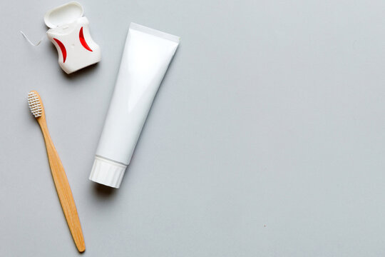 toothpaste and toothbrush top view with copy space on colored background. Flat lay. Dental hygiene. Oral care products on light background. Body care concept
