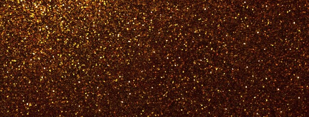 Dark gold sparkling background from small sequins, macro. Shiny bronze glitter backdrop for Christmas or New Year