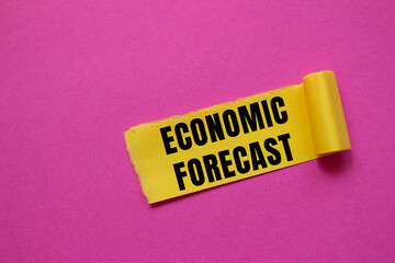 Economic Forecast message written on ripped torn paper background. Conceptual Economic Forecast symbol. Copy space.