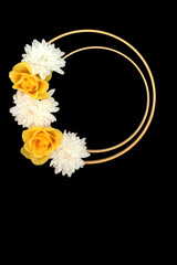 Yellow rose chrysanthemum flower abstract wreath logo decoration design on black background with two wooden circular  frames. Floral garland for greeting card