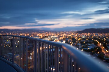 Obraz premium Viewpoint railing overlooking sprawling city lights at dusk, capturing a quiet moment of reflection above the urban landscape.